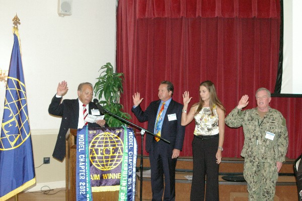 In February, Ramos (l) inducts new members of the chapter’s board.